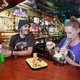 Two customers smoke weed with a bong at the New Amsterdam Cafe in Vancouver, British Columbia on June 20, 2018